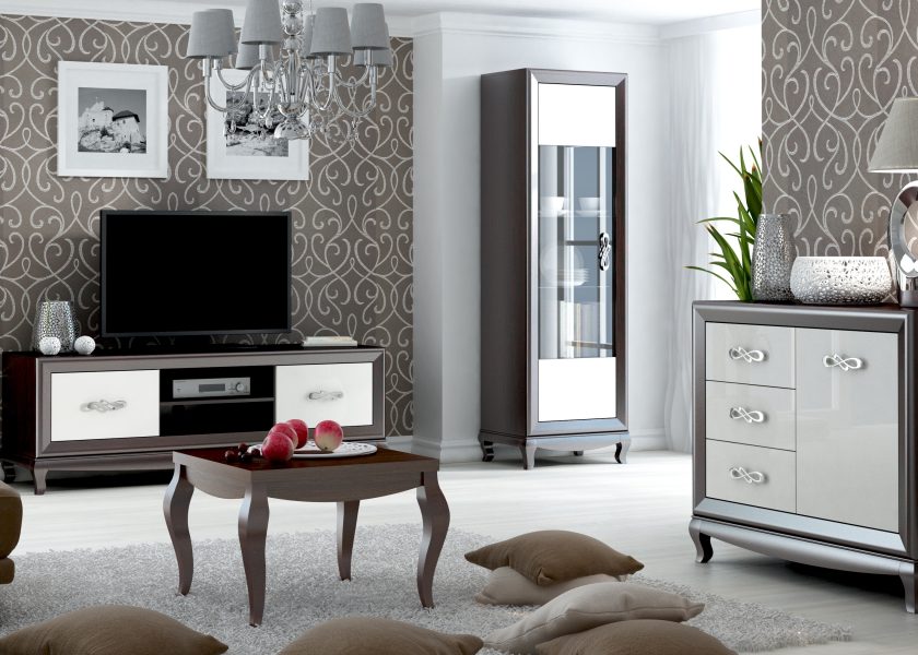 The visualisation shows a living room with furniture from the Sofia collection, a coffee table, a chest of drawers, a glass cabinet and a rtv cabinet, the drawers have decorative handles.