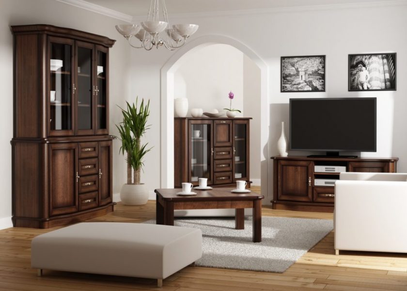 The visualisation shows a living room with furniture from the Julia collection, a coffee table, a display cabinet and a tall rtv cabinet. Julia furniture collection was inspired by the Italian style. It is characterised by rounded shapes of fronts, crowns and plinths. The noble character is added by brass handles that complement the whole. The entire system consists of a total of 46 elements and each of them is available in five colour versions.