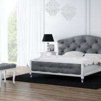 Visualization shows a bedroom, stylish decorative furniture, console with mirror, pouffe and bed have grey quilted upholstery. On both sides of the bed there are bedside tables with lamps.