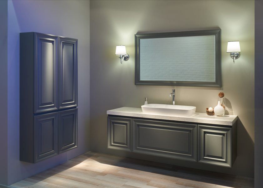 Wnętrze nowoczesnej łazienki z białą umywalką nablatową, dużym lustrem, dwiema lampami elektrycznymi i meblami.